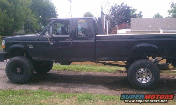 Side view of a black 1994 Ford F-250 pickup truck with lifted suspension and large tires