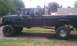 1994 Ford F-250 - This lifted Ford F-250 pickup truck is shown from the side, parked outdoors.