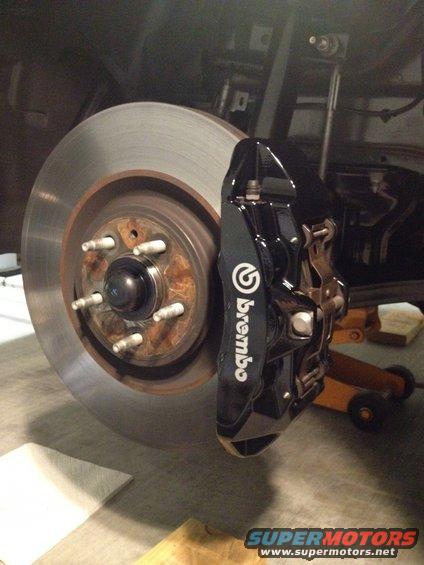 Black Brembo brake caliper with white lettering on a rotor