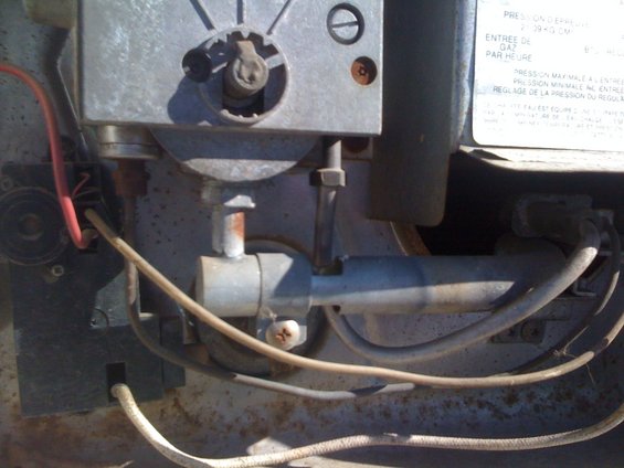 Close-up of a water heater gas control valve with wiring