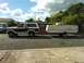 1984 Ford Bronco - Ford Bronco towing a pop-up camper trailer on a street.