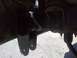 1994 Ford Bronco - Close-up view of vehicle suspension components, showing metal brackets and bolts.