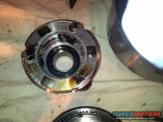 Damaged metal transmission part with visible gear teeth and grease