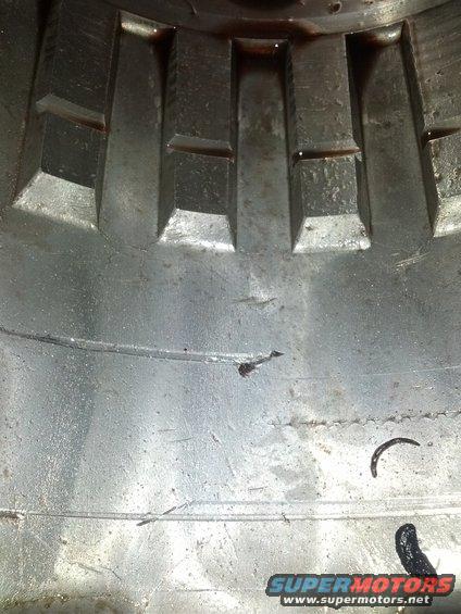 Close-up of a metal transmission component with visible teeth and some oil residue