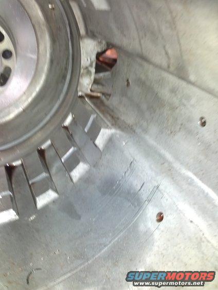 Interior of a transmission housing with visible damage and oil residue
