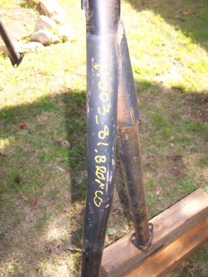Black metal roll bar section with yellow writing: "003_81.BRONCO"
