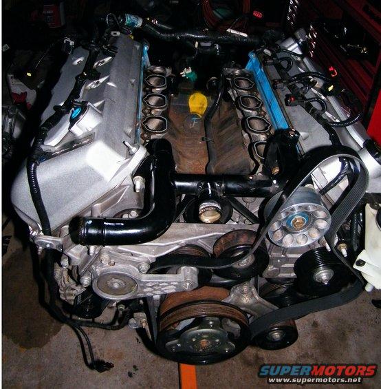 Engine assembly with V-shaped cylinder banks and exposed intake ports