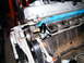 2004 Ford Crown Victoria - Detail of engine components, showing a black fitting and part of the belt drive system.