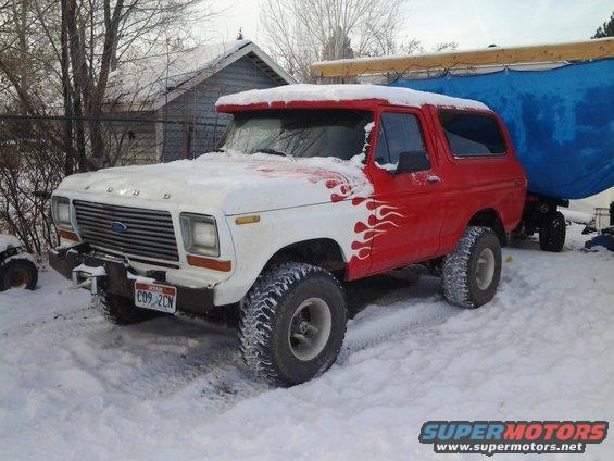 Ford Bronco with flames on the side, covered in snow. License plate reads C09 2CN