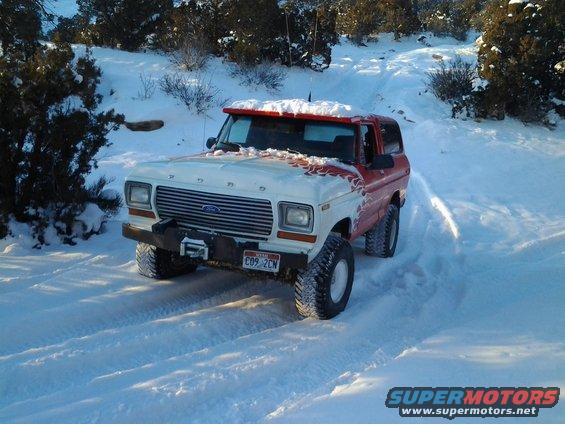 1979 Ford Bronco in snow with red and white paint scheme