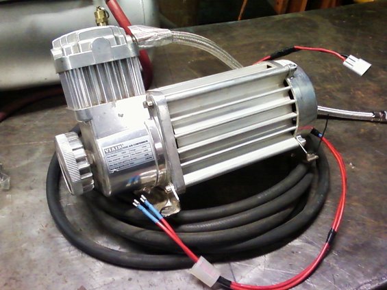 Silver Viair air compressor with black hose and red wires