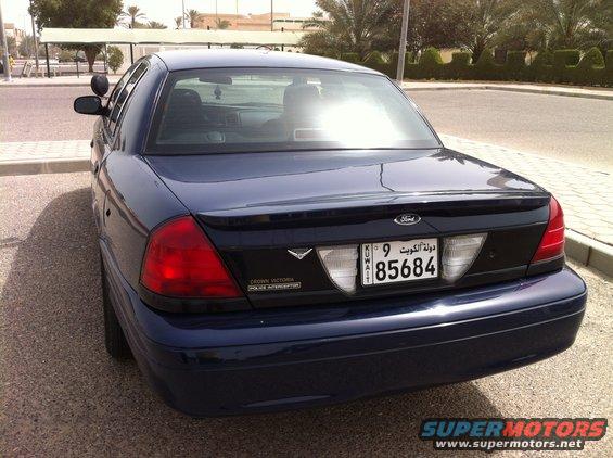 Dark blue 2007 Ford Crown Victoria Police Interceptor, rear view, clean condition, parked on asphalt