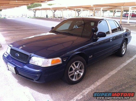 Dark blue 2007 Ford Crown Victoria parked in a lot, front 3/4 view, clean condition