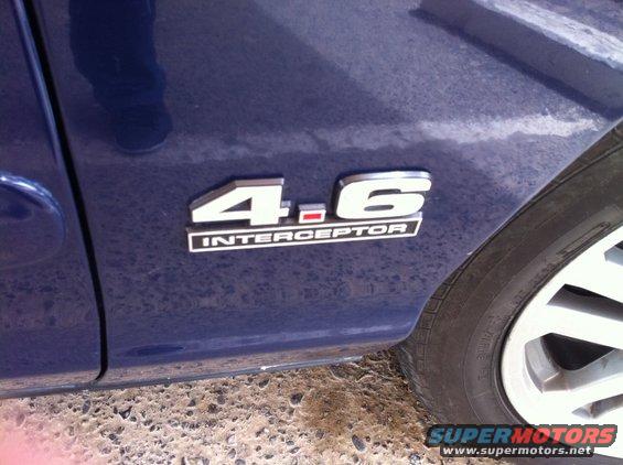 4.6 INTERCEPTOR badge on the side of a blue car