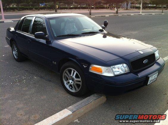 Dark blue 2007 Ford Crown Victoria, 3/4 front view. License plate 85584