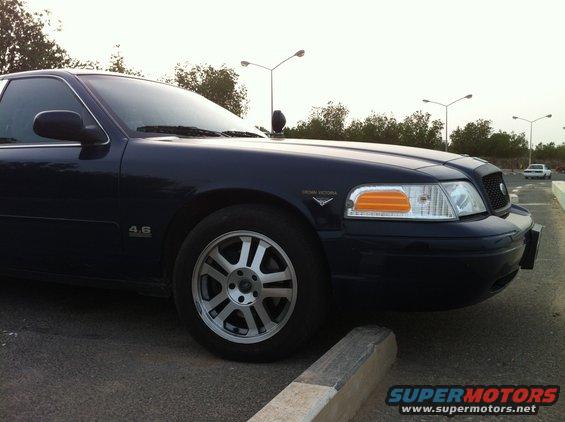 Dark blue 2007 Ford Crown Victoria parked, front quarter view. '4.6' badge visible on fender