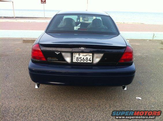 Dark blue 2007 Ford Crown Victoria police car rear view, showing license plate and dual exhaust pipes