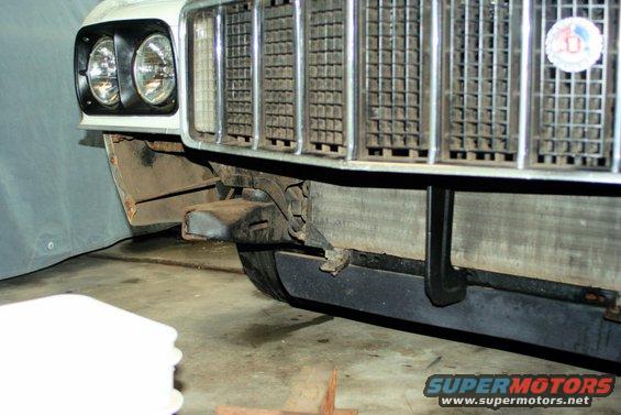 White 1972 Ford Ranchero front grille and headlights, with visible rust on fender