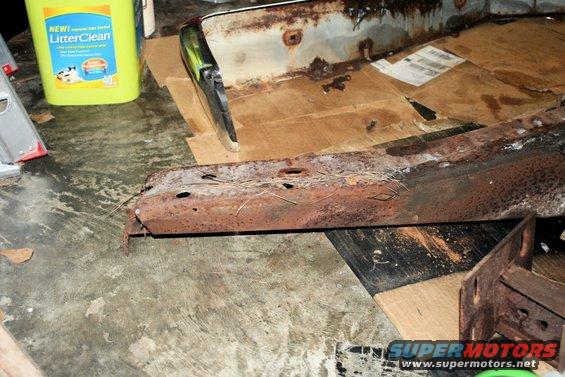 Rusted bumper and frame parts with a bottle of LitterClean