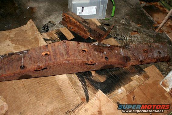 rusted metal frame part on cardboard