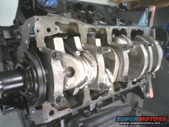 Engine block with crankshaft and connecting rods visible. Some text is visible on the crankshaft