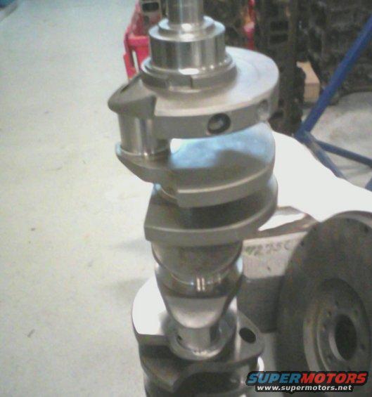 Close-up of a crankshaft, a metal engine component with offset lobes