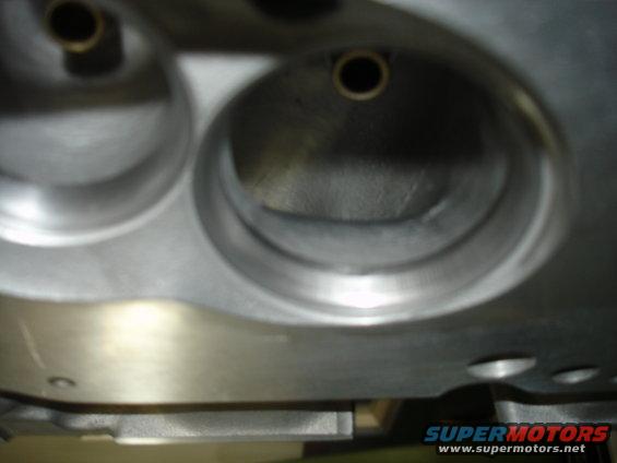 Close-up of a metal engine cylinder head with two visible ports