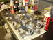1988 Ford Mustang - Engine components including pistons and connecting rods are organized on a surface covered with newspaper.