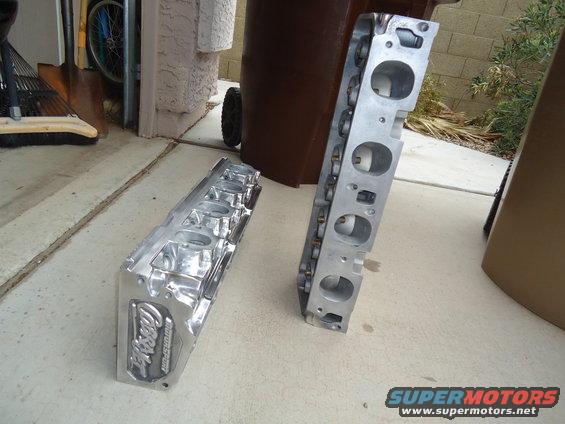Two aluminum engine cylinder heads, one with 'Ford Motorsport' visible