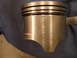 1971 Ford Ranchero - Close-up of an engine piston, showing its construction and ring grooves.