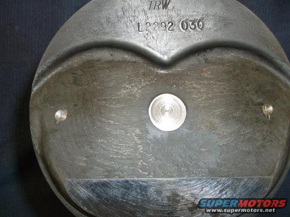 Close-up of a TRW piston with part number L2292 030 stamped on it