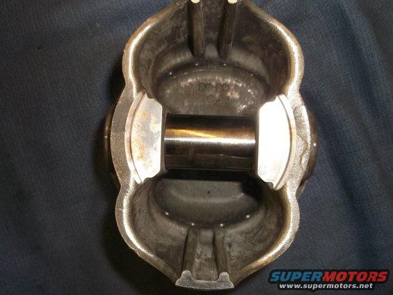 Piston with wrist pin installed, viewed from the open end