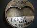 1971 Ford Ranchero - A close-up view of a metal piston with various measurements and notes written on its surface.