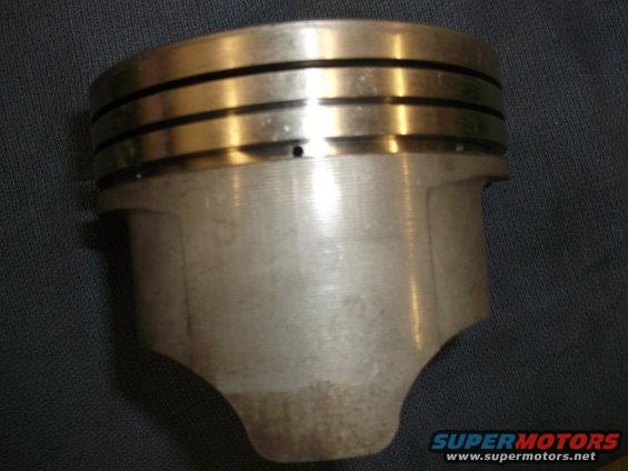 Close-up of an engine piston with three ring grooves at the top