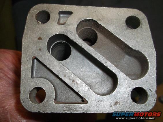 Metal part with complex channels and four bolt holes