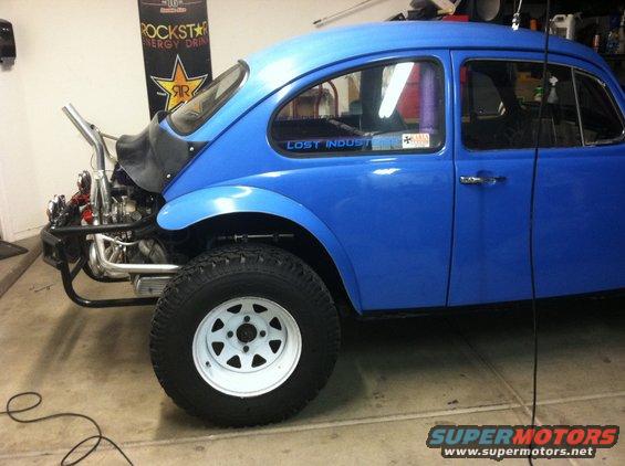 Blue 1970 Volkswagen Beetle Baja Bug with exposed engine and custom exhaust pipe