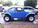 1970 Volkswagen Beetle - A blue Baja Bug conversion sits parked on a driveway next to another vehicle.