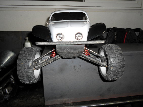 Front view of a white RC car with black fenders and off-road tires