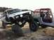 2006 Honda CBR-RR - Two off-road vehicles are parked on a dirt area near a body of water.