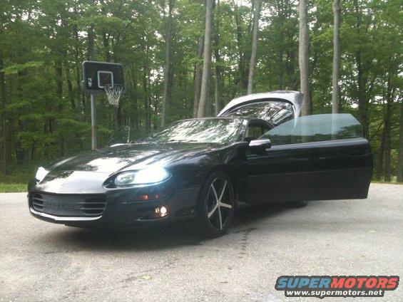 Black 1998 Chevrolet Camaro with driver's door and trunk open, parked outdoors