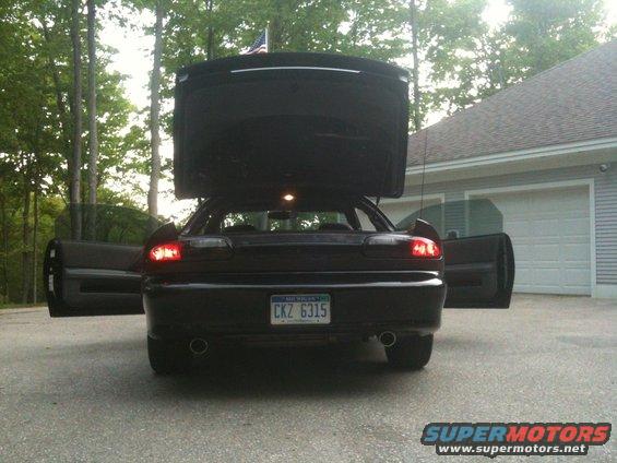 Black 1998 Chevrolet Camaro rear view with trunk and driver's door open. License plate reads CKZ 6315