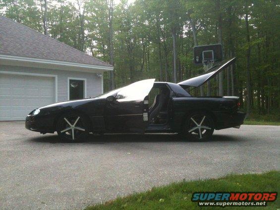 Black 1998 Chevrolet Camaro with doors and trunk open, parked in a driveway