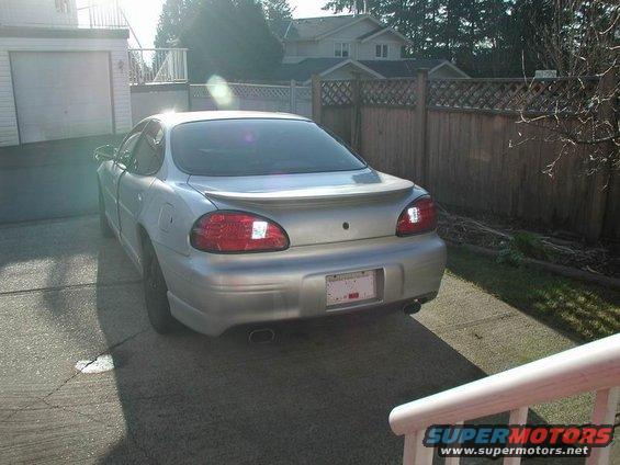 Rear view of a silver 2002 Pontiac Grand Prix parked in a driveway