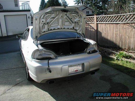 Silver 2002 Pontiac Grand Prix rear with trunk open and damaged taillight