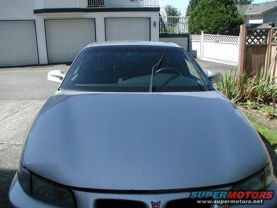 Silver 2002 Pontiac Grand Prix front view, showing hood, windshield, and wipers