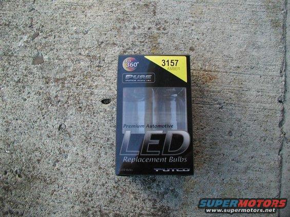 Box of PURE LED replacement bulbs, 3157 Amber, on concrete