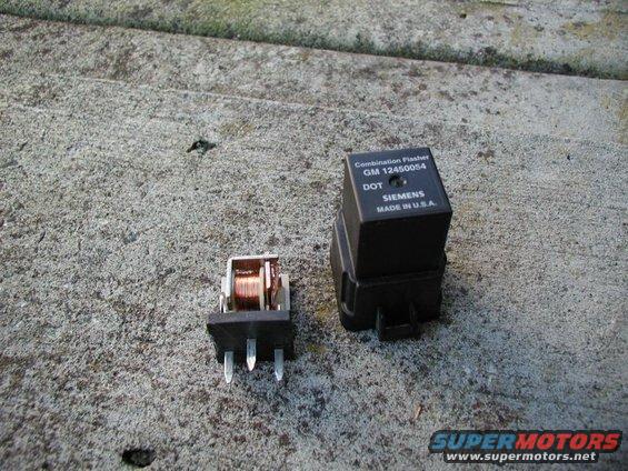 Two automotive relays on a concrete surface. One is a black Siemens combination flasher with part number GM 12450054