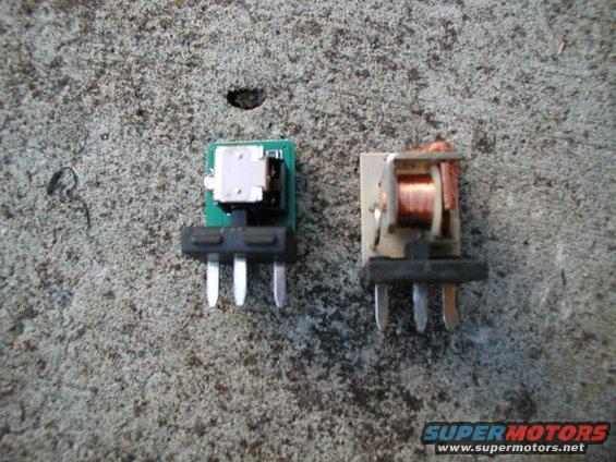two electronic relays on a concrete surface