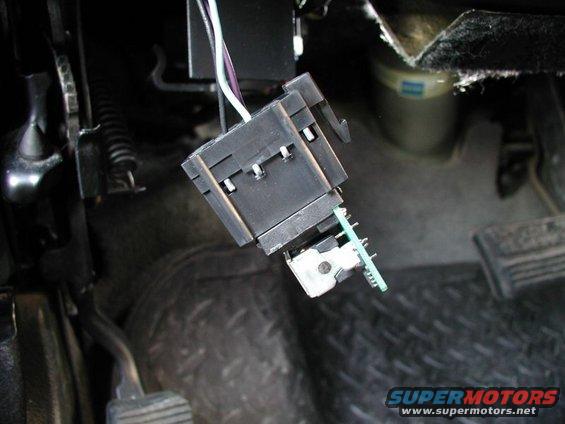 Headlight or dimmer switch connector removed under vehicle dashboard