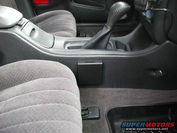 2002 Pontiac Grand Prix interior showing center console with gear shifter, cup holder, and gray seats